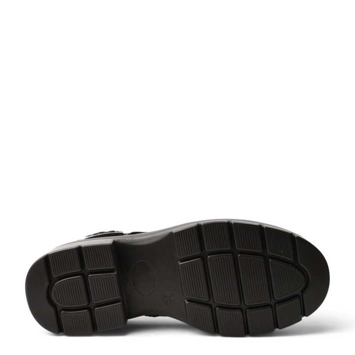 Black rubber sole of an Anna Viotti boot with a textured tread pattern for grip, shown from a bottom view.