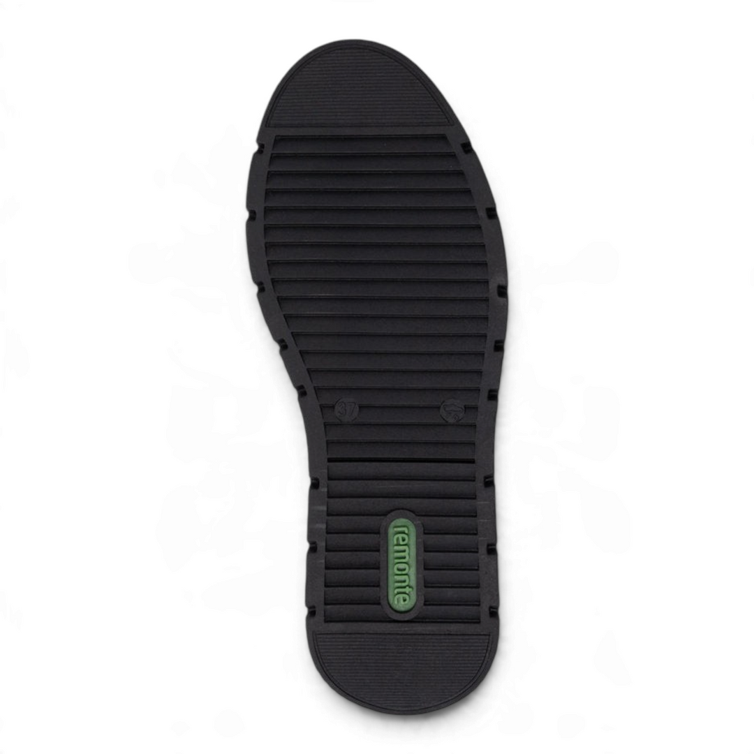 Black textured rubber outsole of a Remonte shoe with a green brand logo, showing a slip-resistant tread pattern.