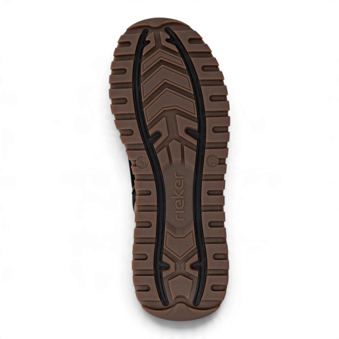 Brown and black lugged rubber outsole of a Rieker men&