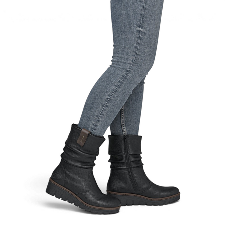 ada-shoes.ro Rieker slouchy black faux leather boots with thick sole and side zipper worn by a woman in jeans