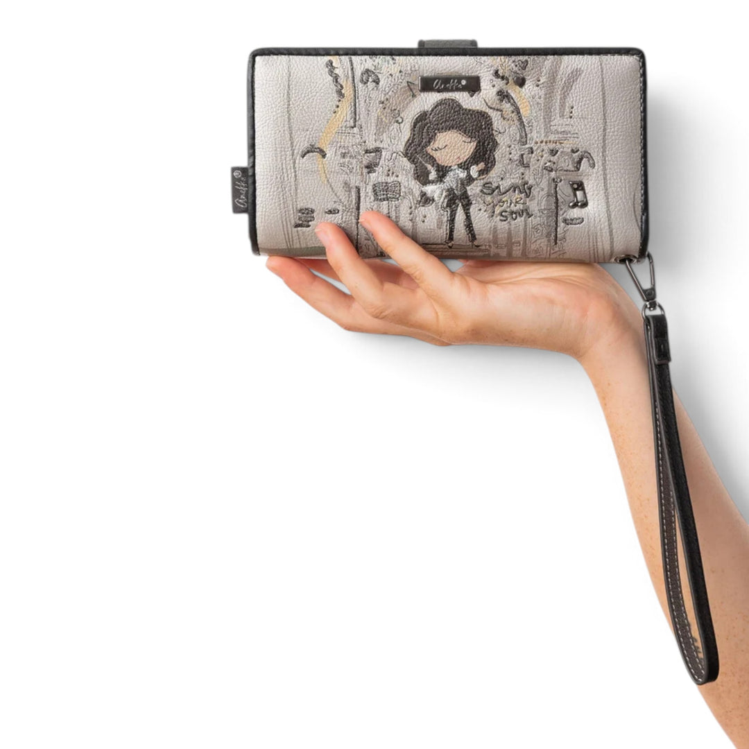 ada-shoes.ro Anekke casual wallet with artistic print, wrist strap, and secure zip closure held in a hand