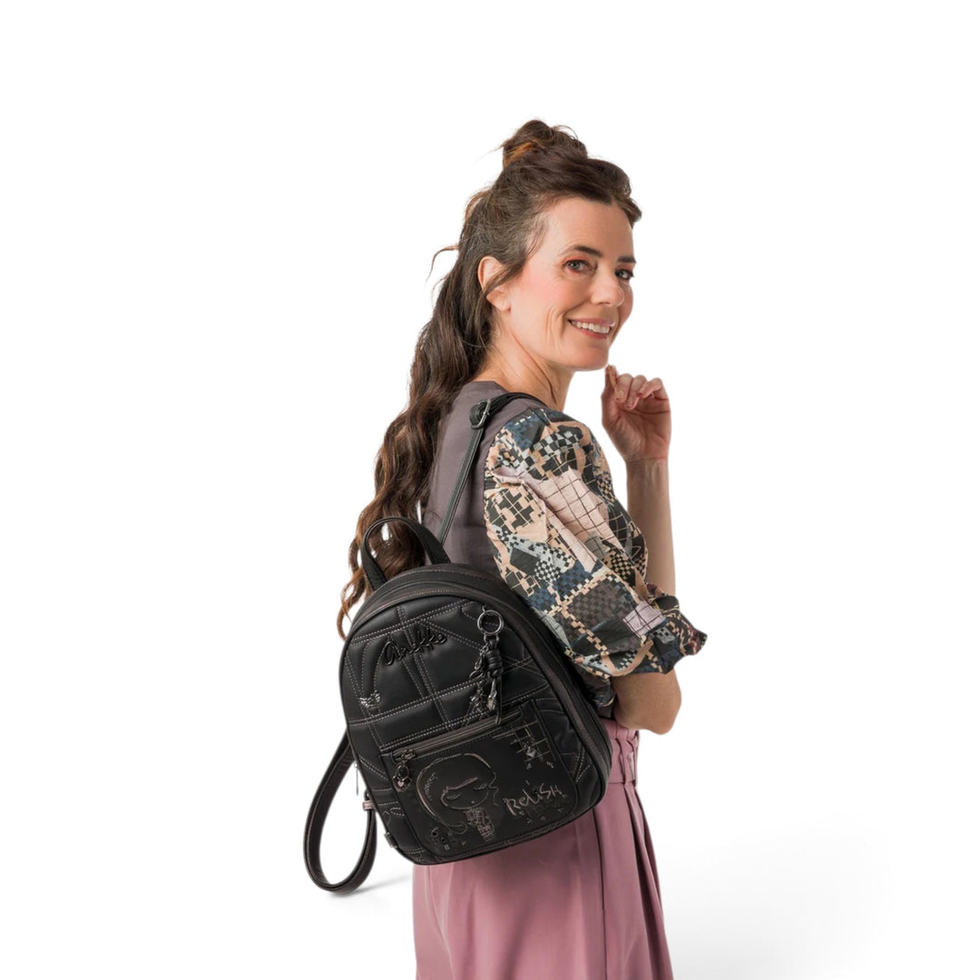 A woman wearing an ada-shoes.ro Anekke black casual backpack with decorative stitching and metallic details.