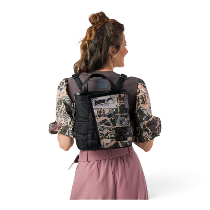 ada-shoes.ro Anekke black casual backpack with patterned panels and metallic details worn by a woman