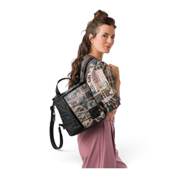 ada-shoes.ro Anekke black casual backpack with patterned panel, metallic details, and heart charm worn by a woman