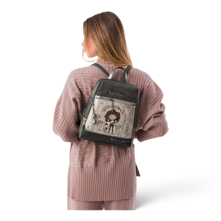 Woman wearing an artistic Anekke casual backpack in grey and taupe with a character print and adjustable straps
