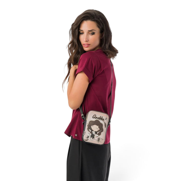 Model wearing an Anekke crossbody bag with a character print, adjustable strap, and zipper closure from ada-shoes.ro