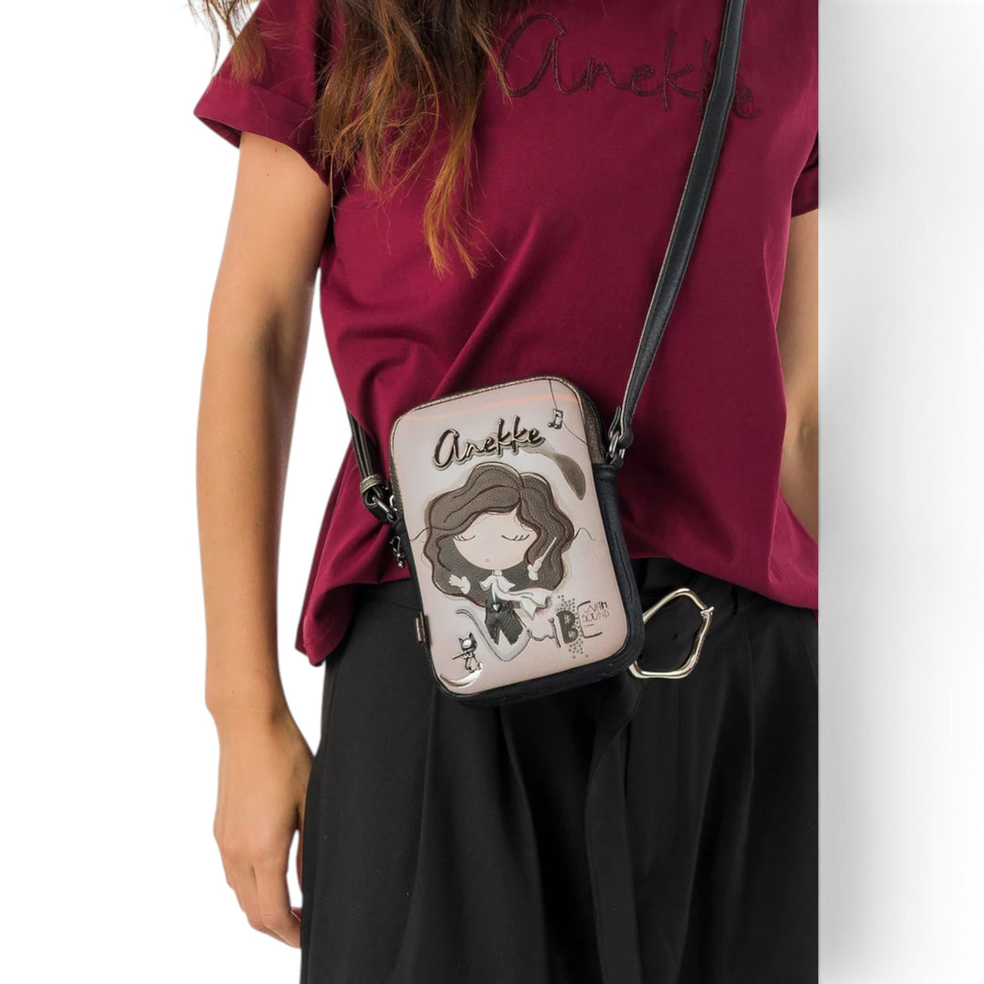 Anekke crossbody bag from ada-shoes.ro featuring a whimsical character illustration, worn as a shoulder bag.