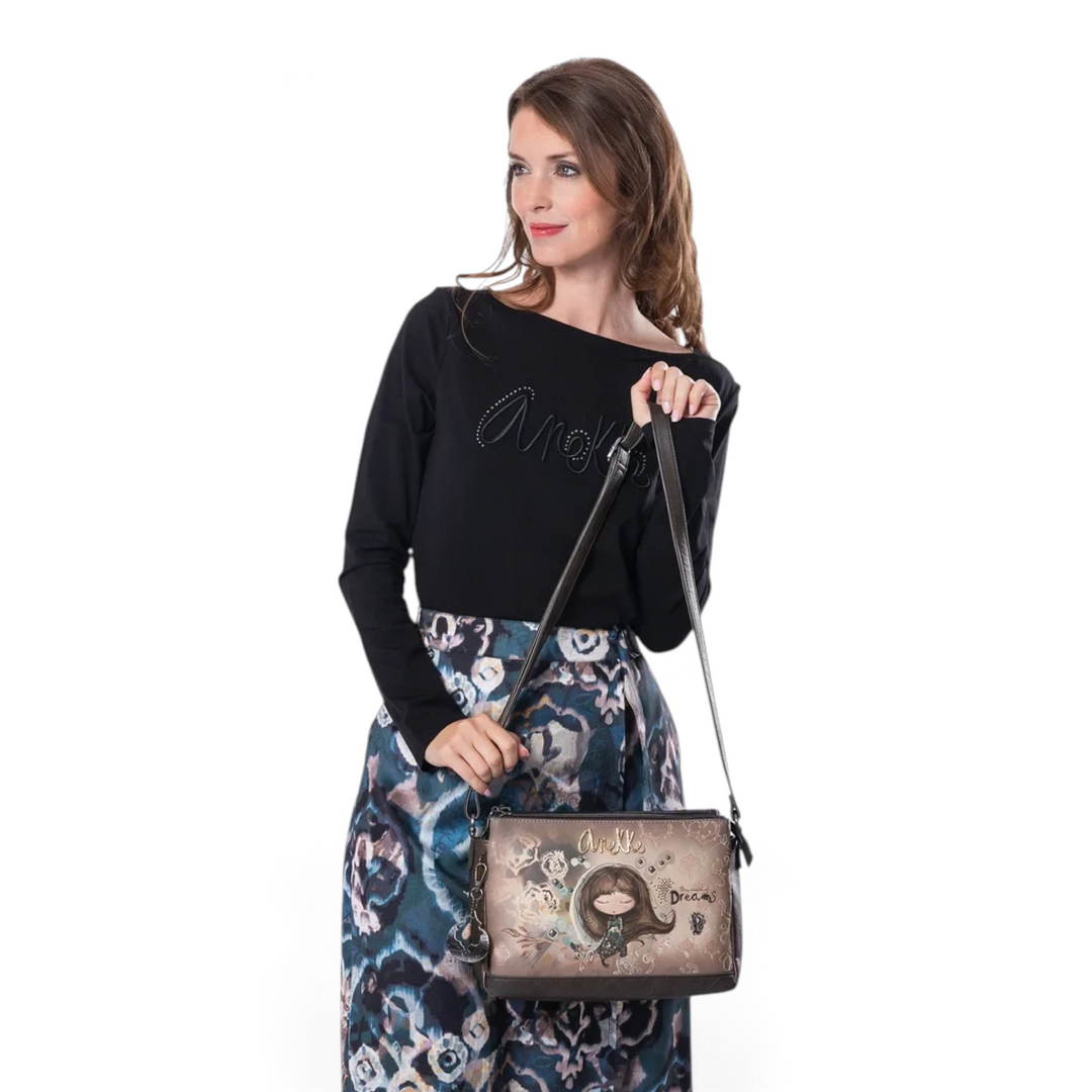 Model wearing an Anekke crossbody bag in taupe and brown faux leather with Dreamverse illustration from ada-shoes.ro