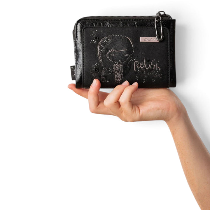 ada-shoes.ro Anekke Iron black PU wallet with RFID protection, zipper closure, and decorative embroidery held in hand