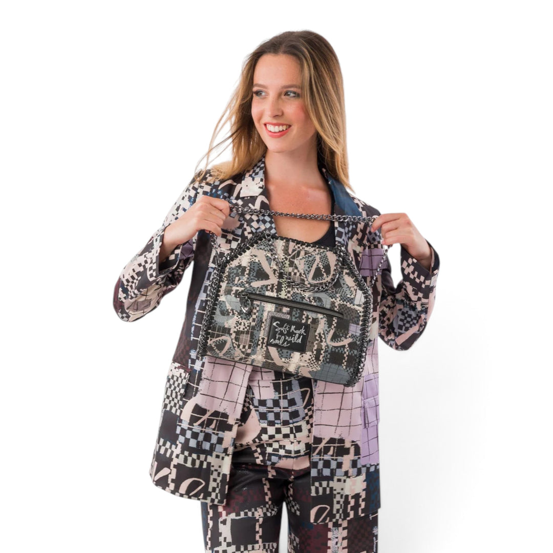 Model wearing an ada-shoes.ro Anekke Iron shoulder bag with a patterned design and metallic chain detail.