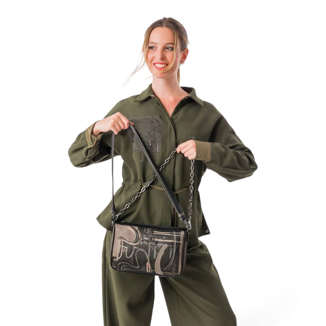 ada-shoes.ro Anekke Melody crossbody bag with decorative chain strap worn by a smiling woman in a green jumpsuit