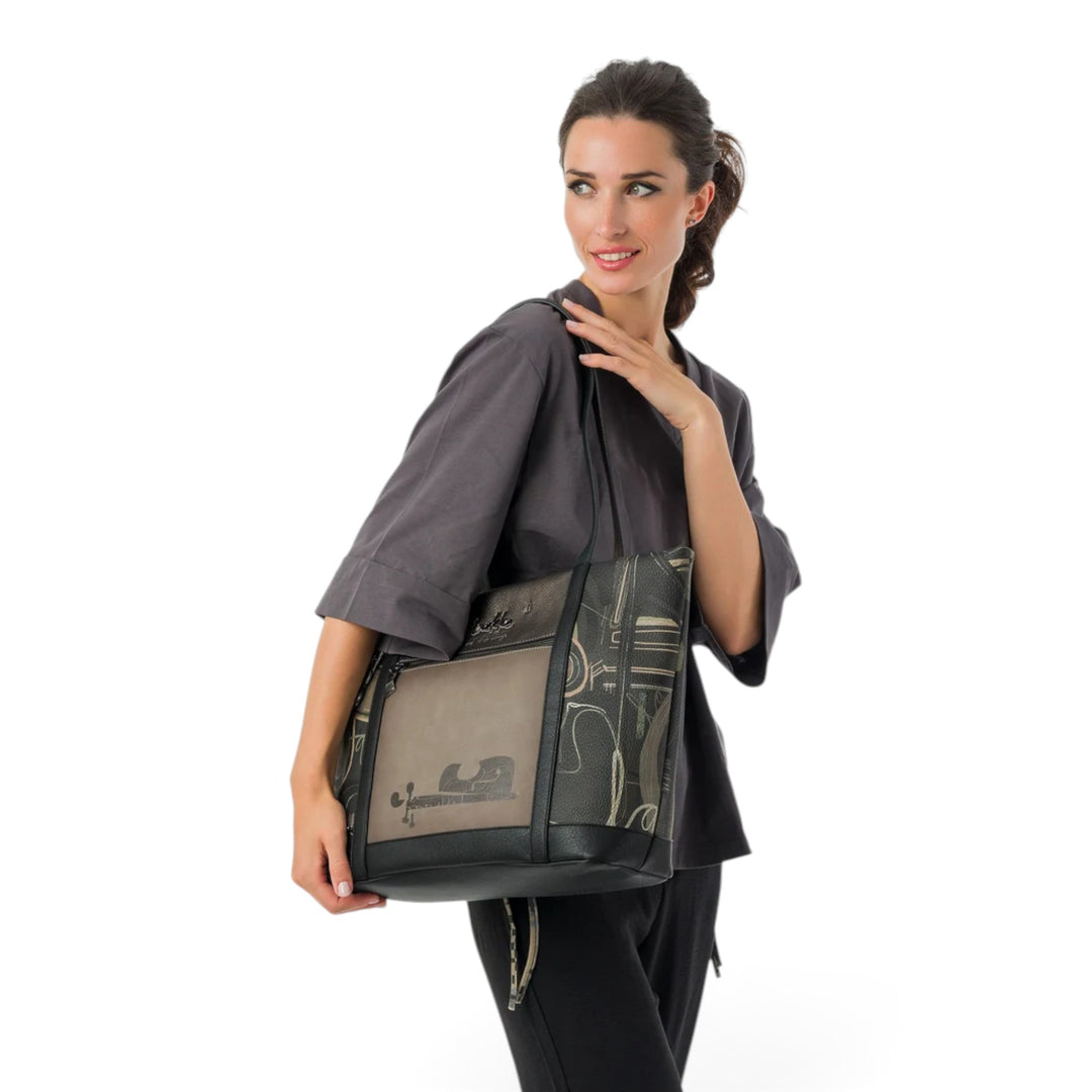 ada-shoes.ro Anekke Melody shoulder bag with musical print, worn by a model in a grey top against a white background.