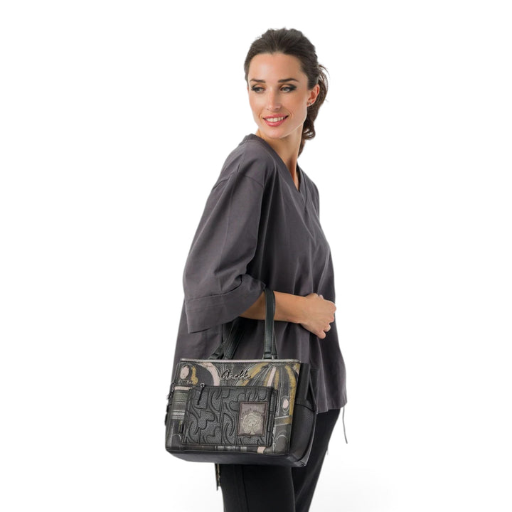 Woman carrying an Anekke Melody casual shoulder bag with unique musical-themed patterns and front pocket detail