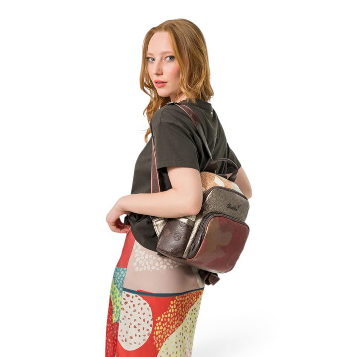 ada-shoes.ro Anekke Odyssey casual backpack in brown and metallic tones worn by a woman with adjustable straps