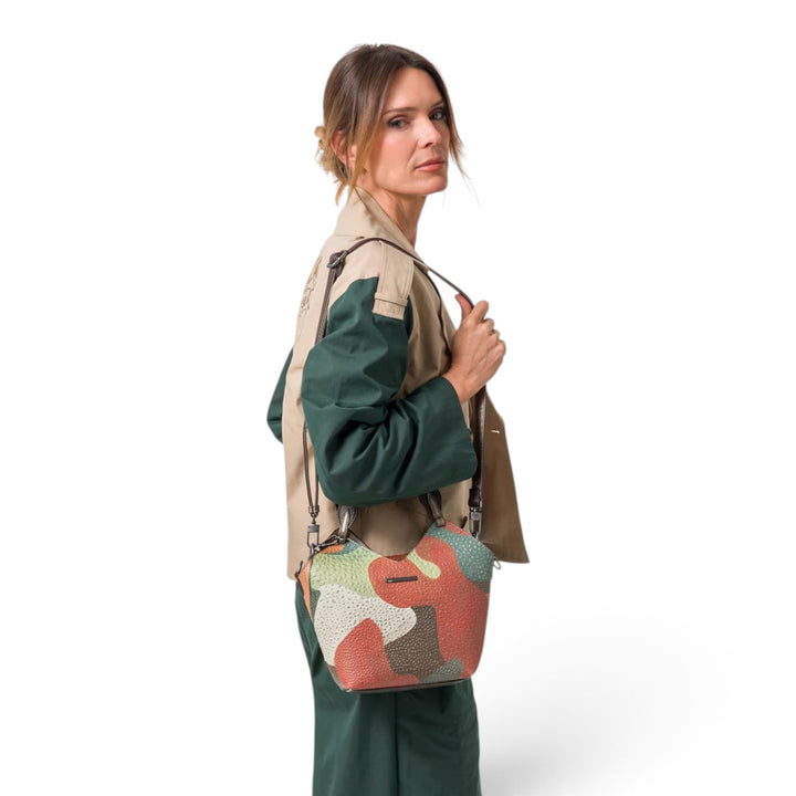 ada-shoes.ro Anekke Odyssey 2-in-1 crossbody bag with colorful abstract print, worn by a woman in a green outfit