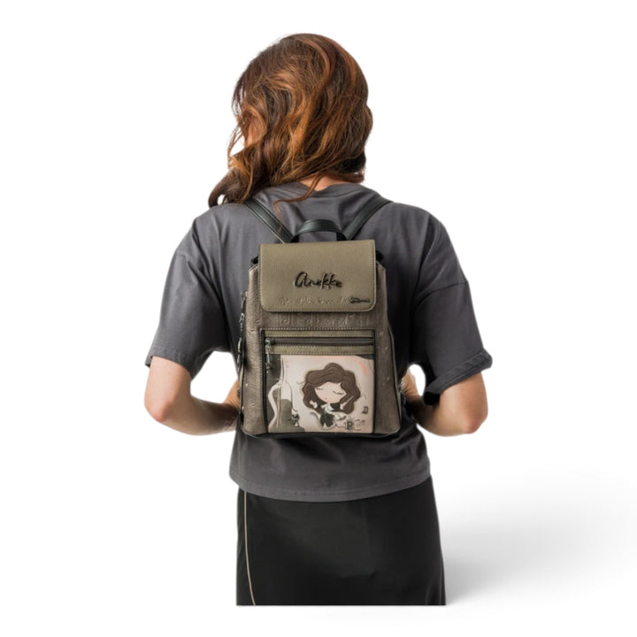 Woman wearing an Anekke Orchestra casual backpack with artistic musical illustration, back view.