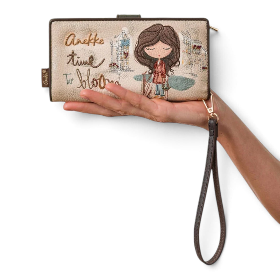 ada-shoes.ro Anekke Tulip large beige wallet with floral embroidery and wrist strap held in a hand