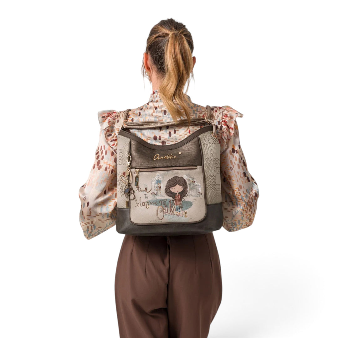 ada-shoes.ro Anekke Tulip convertible shoulder bag and backpack worn by a woman, featuring artistic floral print.
