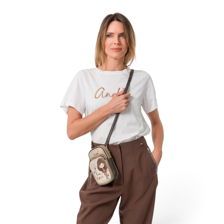 Woman wearing an ada-shoes.ro Anekke Tulip crossbody bag with a small, illustrated design and adjustable strap.
