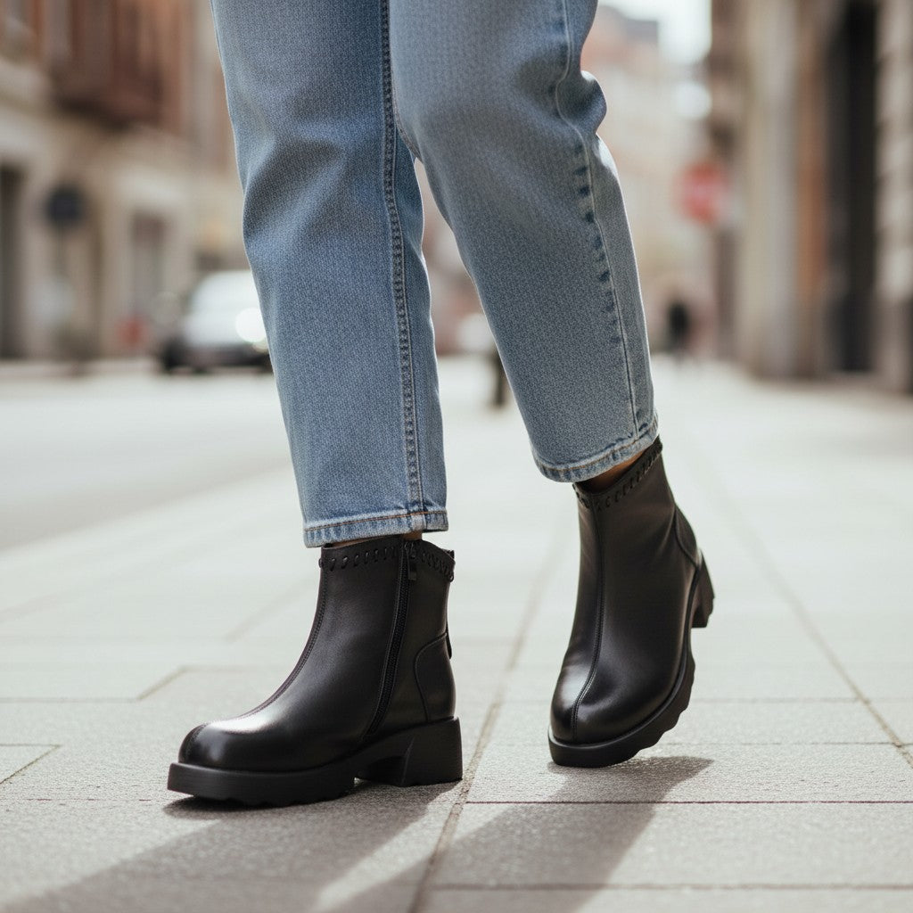 ada-shoes.ro Formazione black leather ankle boots with a 4.5cm platform sole worn with light blue jeans on a city street