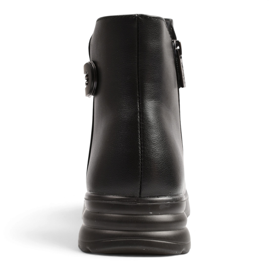 Back view of black leather Pass Collection ankle boots with a thick, ridged sole and side buckle detail.
