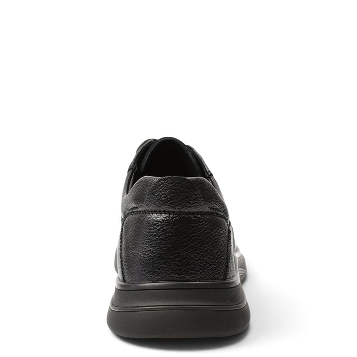 ada-shoes.ro black leather casual shoes with a flexible sole, seen from the back, featuring a textured finish.