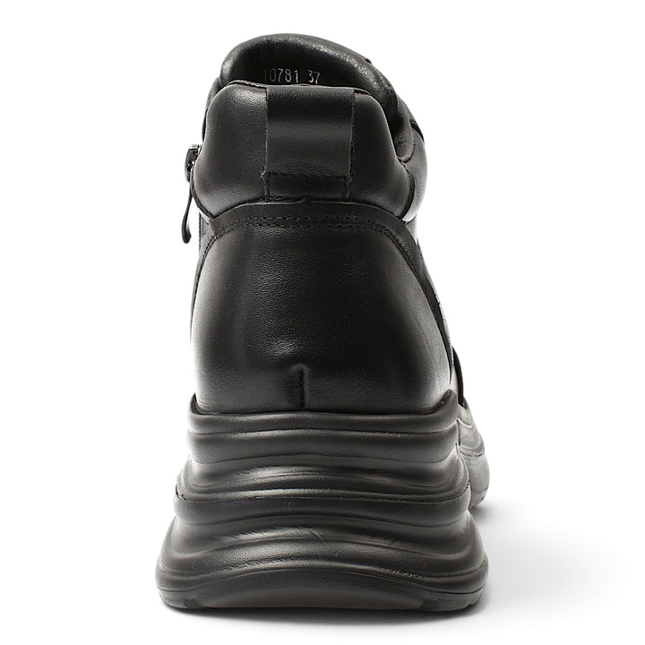 Back view of black leather ADA SHOES 10781 sport boots with a thick 5 cm platform sole on a white background