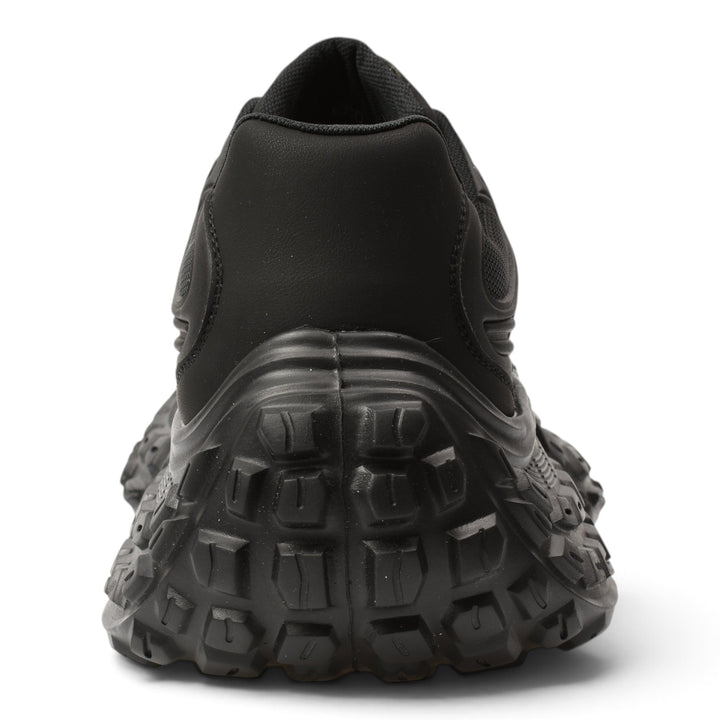 Back view of ada-shoes.ro 6050-N black leather and textile sneakers with a thick, textured, flexible rubber sole.