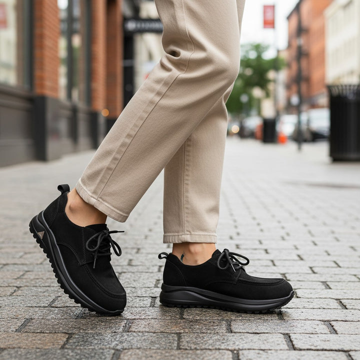 ada-shoes.ro black nubuck leather sneakers with lace-up closure and flexible soles worn on a city street