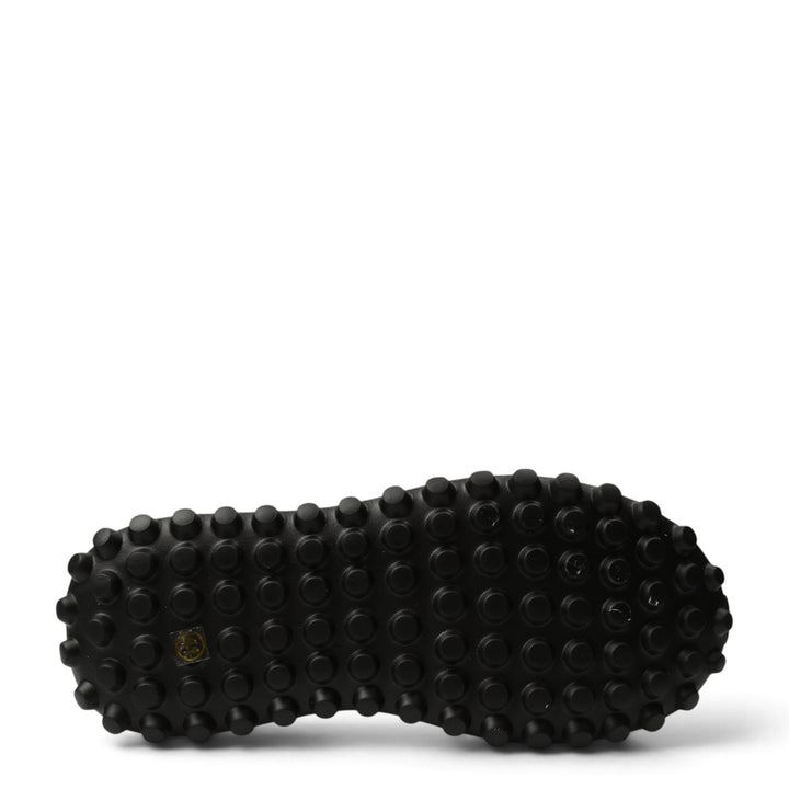 Black rubber outsole of ada-shoes.ro 7077 sneakers featuring a textured grip pattern for stability