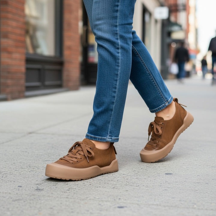 ada-shoes.ro brown nubuck leather sneakers with lace-up closure and flexible rubber soles worn with blue jeans