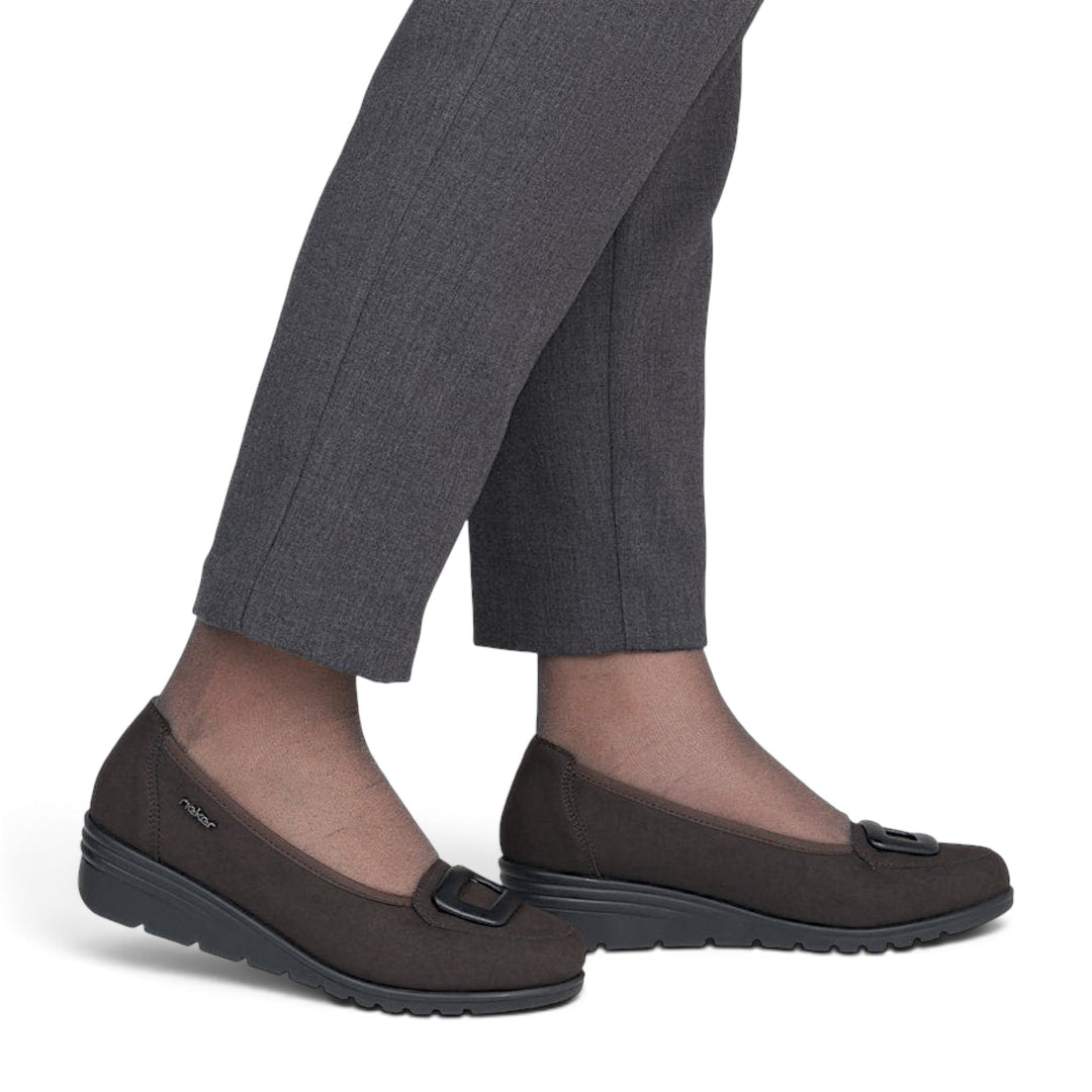 ada-shoes.ro brown suede Rieker casual shoes with a comfortable wedge sole and decorative buckle detail on feet