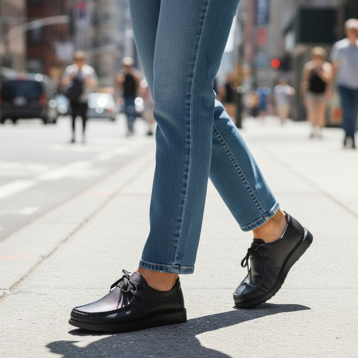 ada-shoes.ro Goretti casual black leather shoes worn with blue jeans on a city street