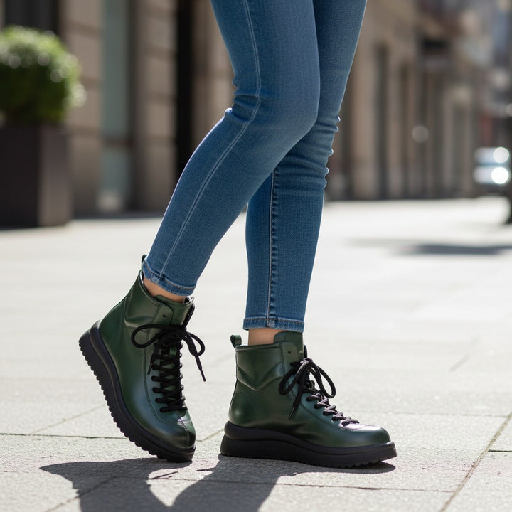 ada-shoes.ro green leather casual ankle boots with black laces and thick soles worn with blue jeans on a city street