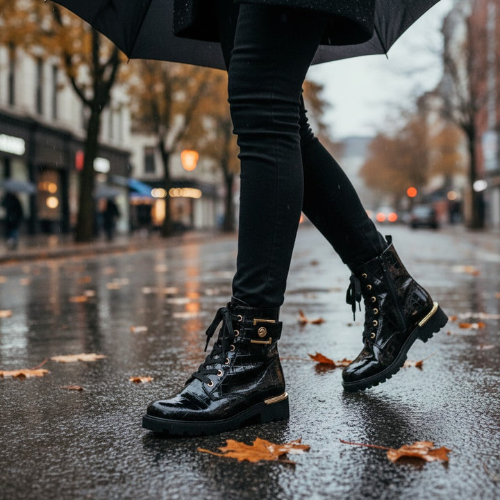 ada-shoes.ro Remonte black crocodile-textured biker boots with gold buckle and lace-up detail worn on a rainy street