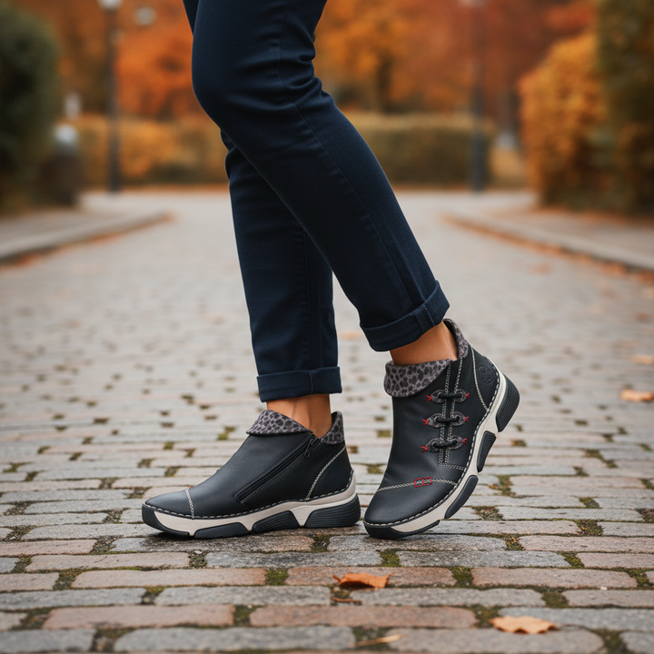 ada-shoes.ro Rieker black faux leather ankle boots with side zipper, felt lining, and cushioned sole on cobblestone path