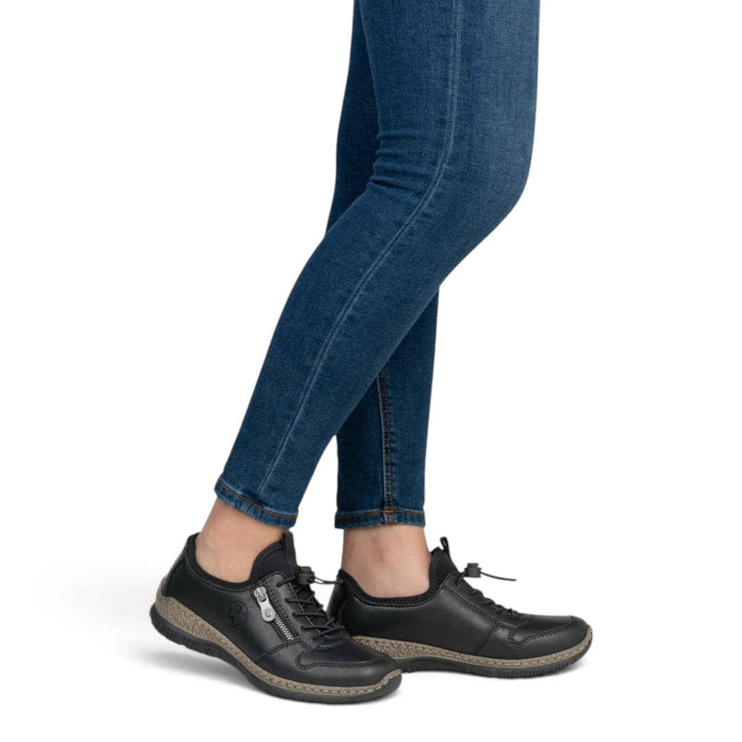 ada-shoes.ro Rieker black slip-on casual shoes with side zipper and elastic laces worn with blue jeans