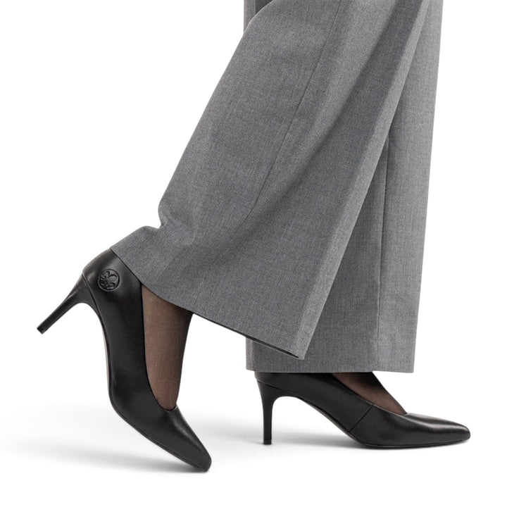 ada-shoes.ro Rieker black leather stiletto pumps with a 7cm heel and pointed toe worn with grey trousers