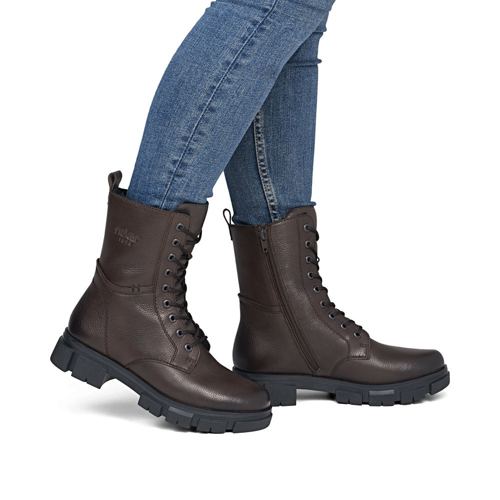 ada-shoes.ro Rieker dark brown combat boots with lace-up front, side zipper, and thick lug sole worn with blue jeans