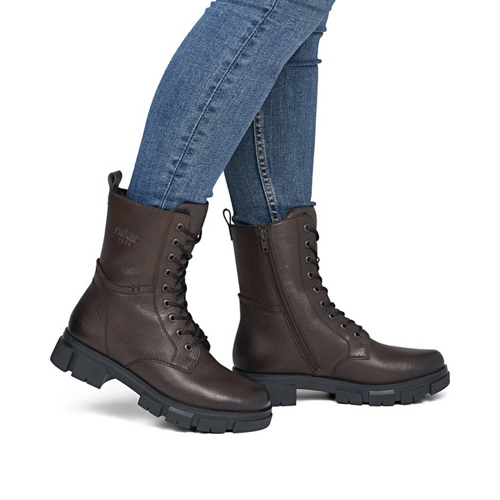 ada-shoes.ro Rieker dark brown combat boots with lace-up front, side zipper, and thick lug sole worn with blue jeans