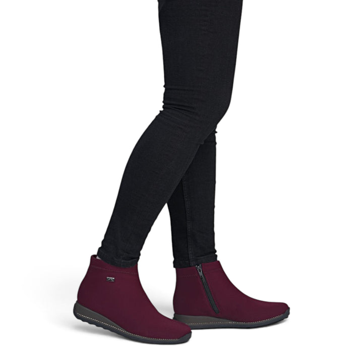 ada-shoes.ro Rieker burgundy stretch fabric ankle boots with warm lining, side zipper, and flexible sole on a model