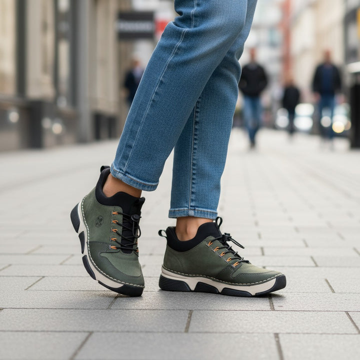 ada-shoes.ro RIEKER khaki green casual sneakers with orange accents and elastic drawstring closure on city street