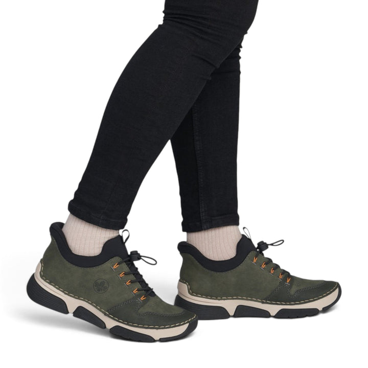 ada-shoes.ro RIEKER khaki green casual sneakers with orange accents, elastic laces, and flexible grip sole on model