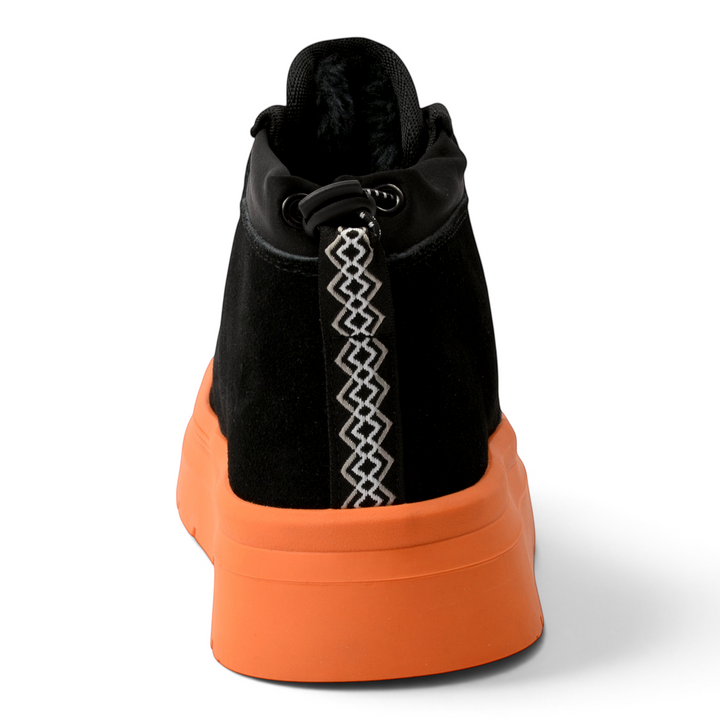 ada-shoes.ro black suede ankle boots with a thick orange sole and patterned heel pull tab, rear view.