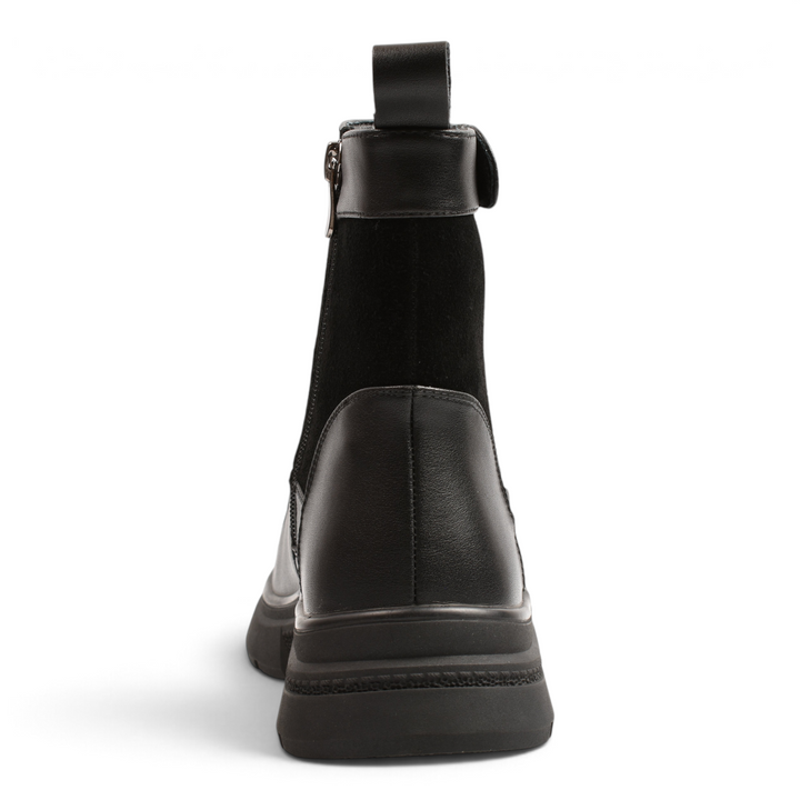 Back view of black Anna Viotti ankle boots featuring smooth and suede leather textures with a thick track sole
