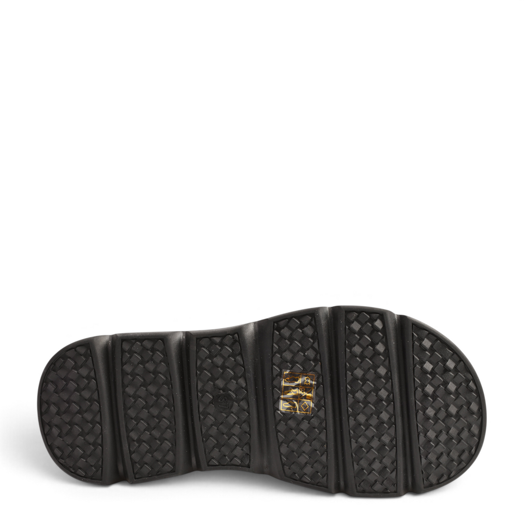 Black rubber sole of ada-shoes.ro boots with a textured, non-slip tread pattern for optimal grip.