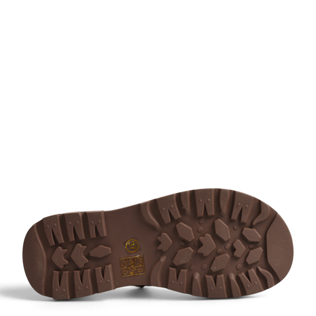 Brown lug sole of Ada Shoes 68001-K boots with deep tread pattern for traction and stability