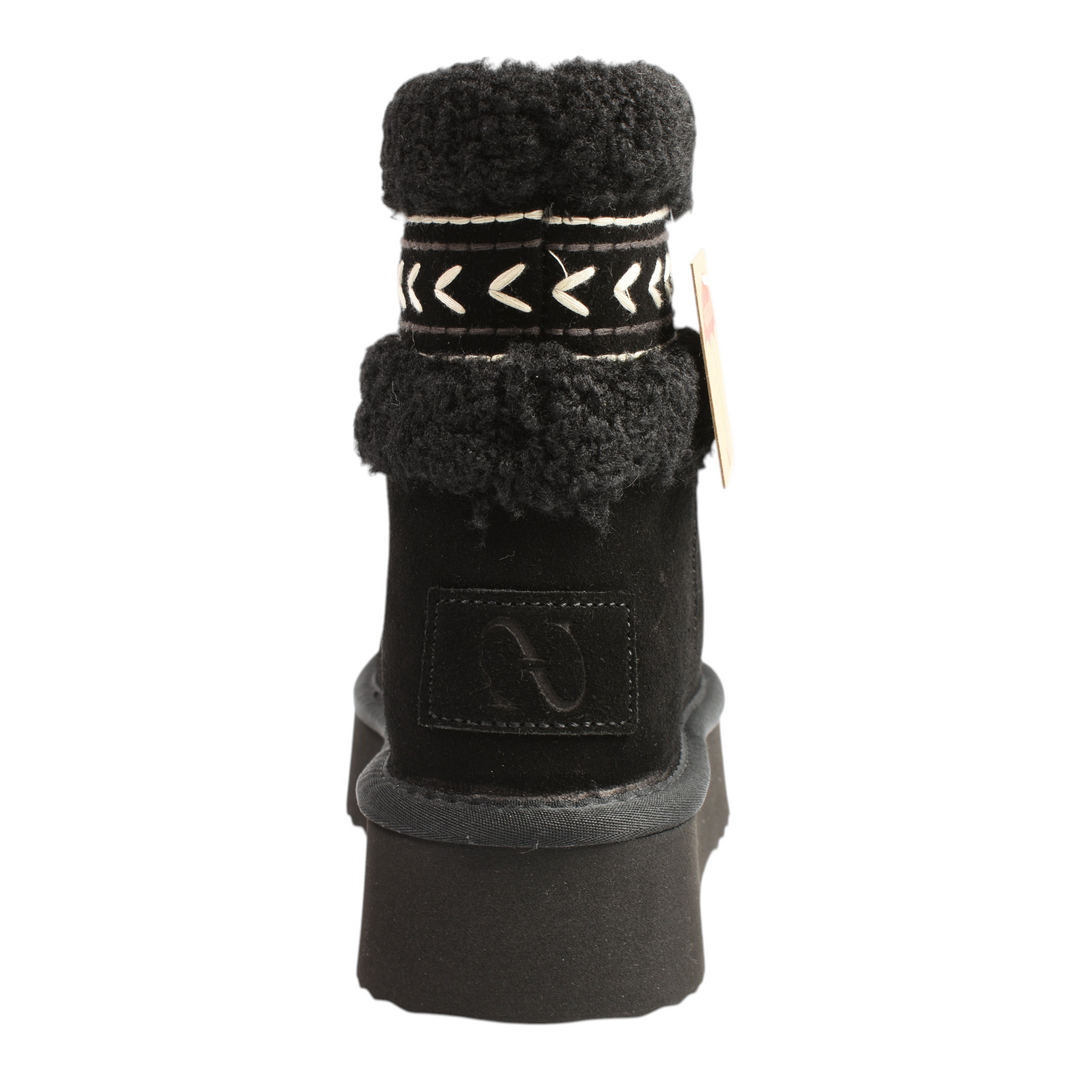 Back view of black Anna Viotti suede winter boots with faux fur collar, platform sole, and white ethnic embroidery.