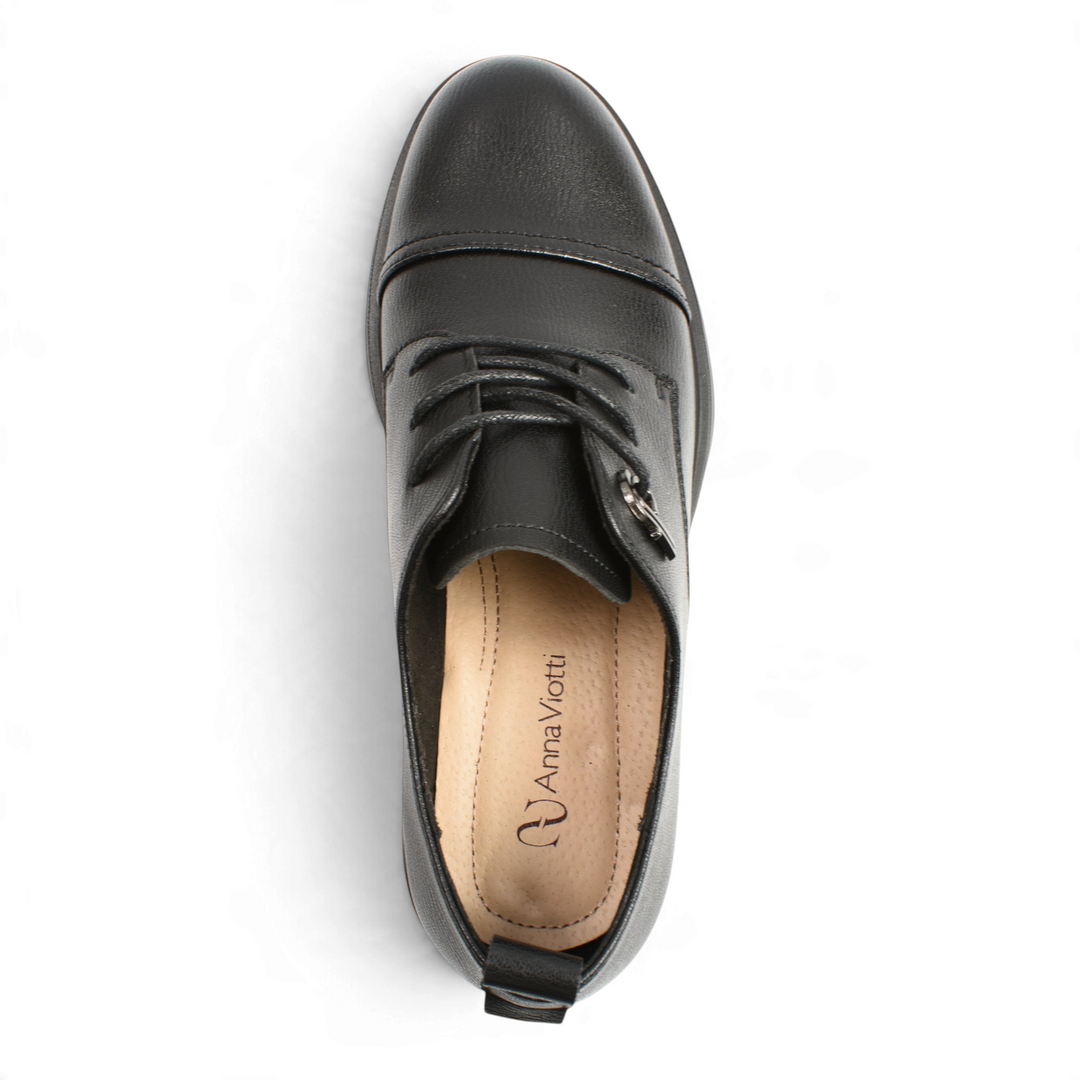 Top view of black leather Anna Viotti derby shoes with cap-toe detail, flexible laces, and cushioned insole.