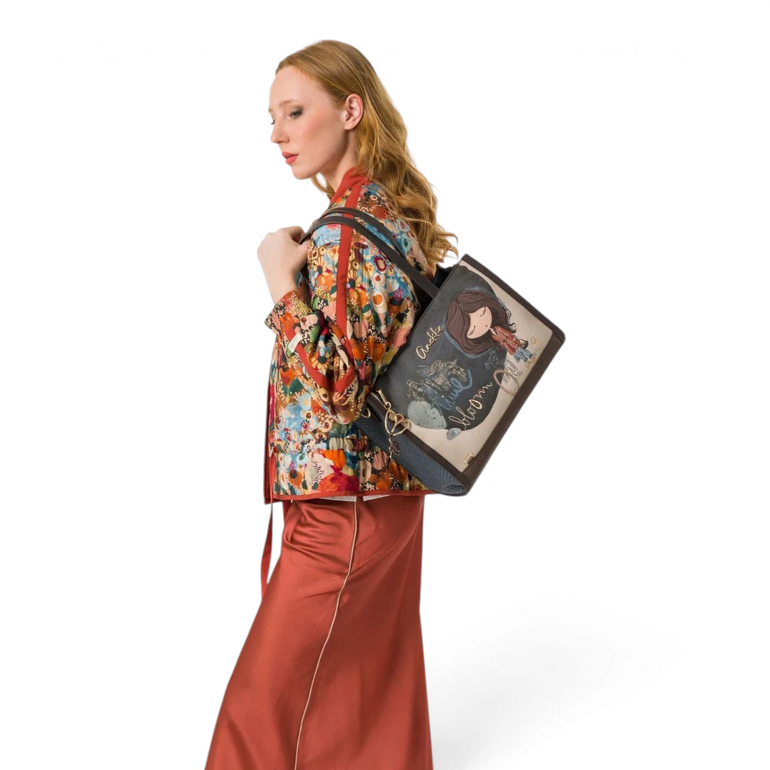 Model wearing an ada-shoes.ro Anekke Bloom shopper bag with artistic print, shoulder straps, and gold metal details.